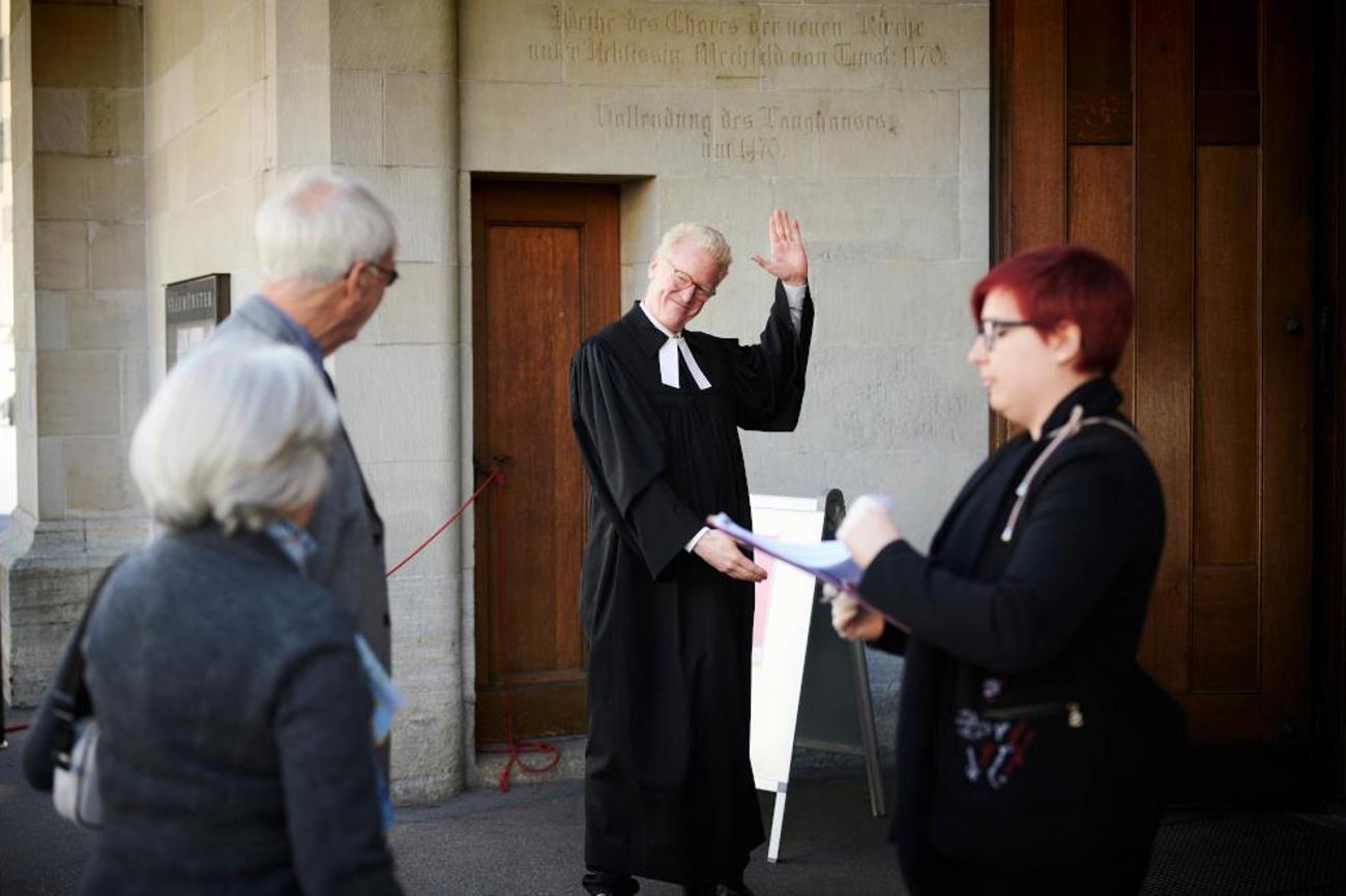 Endlich: Pfarrer Niklaus Peter begrüsst die Gottesdienst-Besucher auf Abstand. |Martin Guggisberg / reformiert.