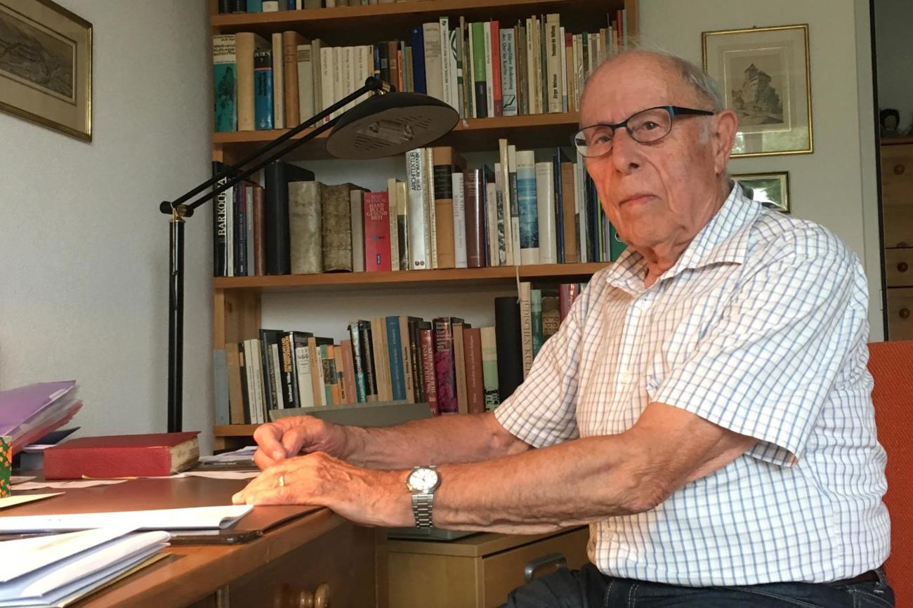 Pfarrer Walter von Arburg sitzt an seinem Arbeitstisch. Als Präsident der Redaktionskommission hat er den Kirchenboten lange Zeit mitgeprägt. (Bild: es)